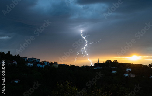 Lightning is flashing at sunset.