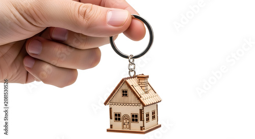 Hand holding house-shaped keychain close-up