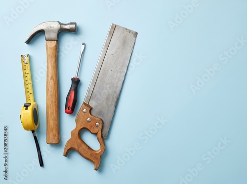 Carpenter Tools on Pastel Blue Background Construction Concept