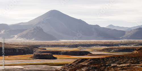Quadro su tela A winding seasonal riverbed carved through the vast landscapes of Tibet, China