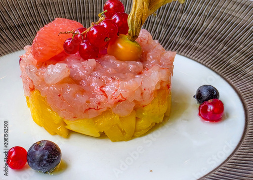 Exquisite shrimp tartare with redcurrants and physalis

