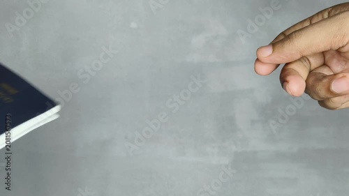 Closeup of International traveller person hand showing or giving official indian passport to other to check his identity and nationality. Personal identification travel document concept.