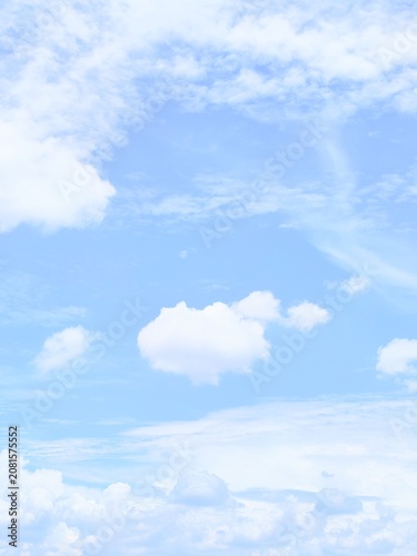 Blue sky background with soft white clouds, natural clear sky texture for wallpaper and design element