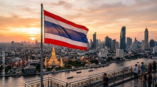 Waving Thailand flag overlooking the Bangkok city skyline at sunset with river view and temple
