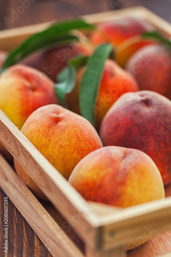 Fresh peaches in a wooden basket