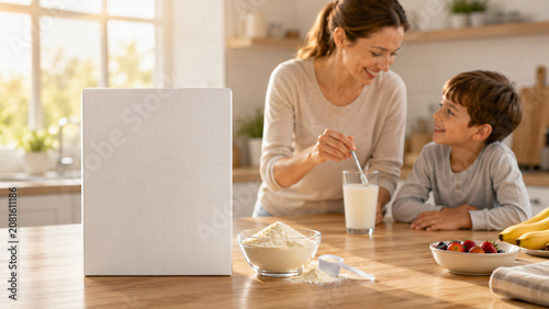 Mother and Son Preparing Healthy Powdered Milk Drink with Blank Milk Powder Box Mockup in Sunlit Kitchen