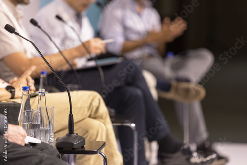 Business panel discussion with speakers and microphones at corporate conference, leadership forum and executive event, round table political meeting