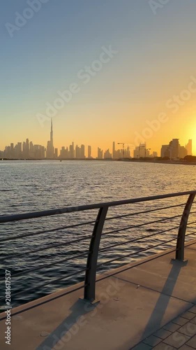 Evening cityscape of Dubai with Burj Khalifa and surrounding skyscrapers silhouetted against the fading light of sunset