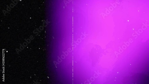 Cinematic colorful light leaks move across black background with heavy film grain and dust particles. Ideal for retro film edits or creative video transitions.