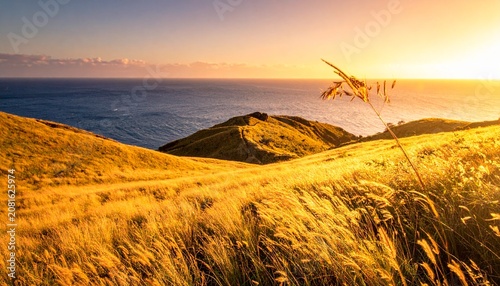 Golden hour over rolling hills and distant mountains.