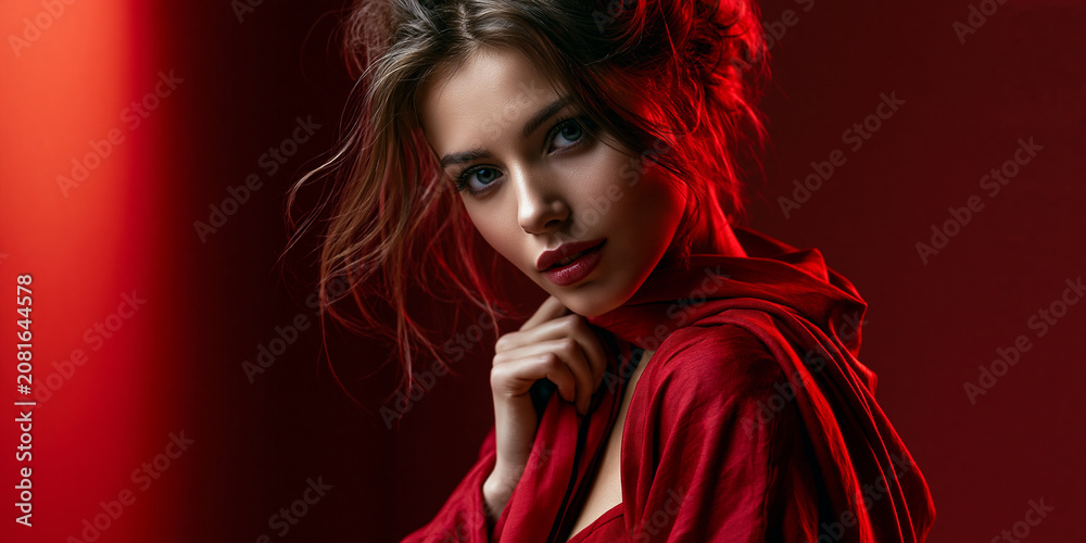 Fototapeta premium young woman in red with curious look, curious young woman portrait, thoughtful young woman looking with curiosity