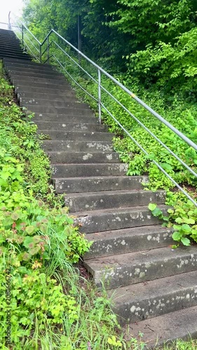 Stone concrete stairs leading upwards in a green park