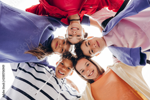 Fotografie Close group of teenage friends looking down at camera in circle