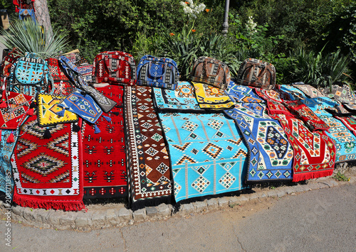 Colorful Handmade rugs and bags for sale by park with  Plants in Belgrade, Serbia
