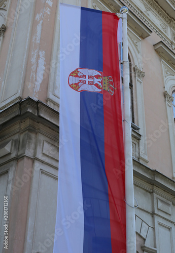 Long  Flagpole with Long Serbian Flag by Historic Old Building in Belgrade, Serbia