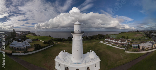 MacQuarie lighthouse panorama in Sydney, Australia from aerial view with ocean and dramatic stormy sky in the background
