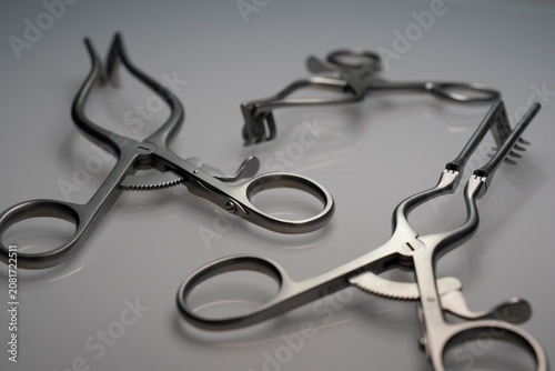 Surgical Spreader Instruments On Reflective Gray Surface