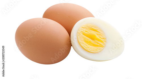 Photos Two whole brown eggs and one halved hard-boiled egg with yellow yolk, isolated o