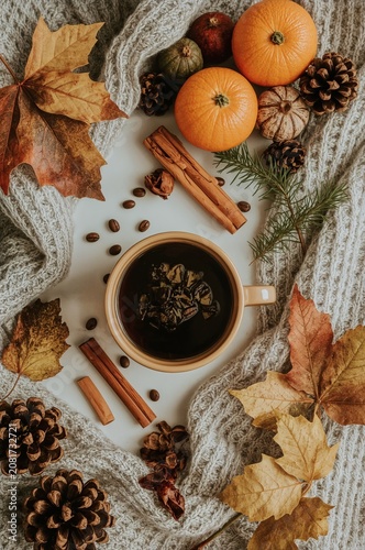 Warm Drink and Autumn Decor With Leaves, Spices, Oranges, and Pine Cones on a...