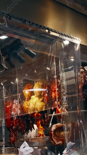 Roasted ducks and meats hanging behind a glass display in a restaurant setting collectively known siu mei, a classic authentic local Cantonese dish in Hong Kong