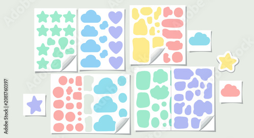 Colorful sticker sheets arranged in a collage on a light wall