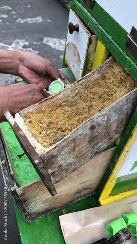 Street vendor preparing traditional Indonesian snack called 