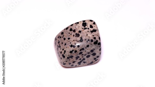 Aplite arfvedsonite dalmatian tumbled stone isolated white background