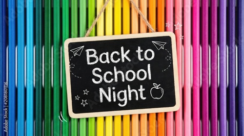 Colorful back to school night sign with crayons background