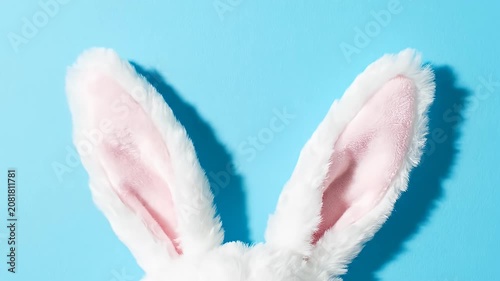 White bunny ears on bright blue background.