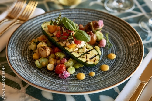 Grilled zucchini filled with fresh vegetables, basil, and sauce