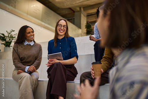 Obraz na plátně Diverse women coworkers collaborating and smiling in office setting