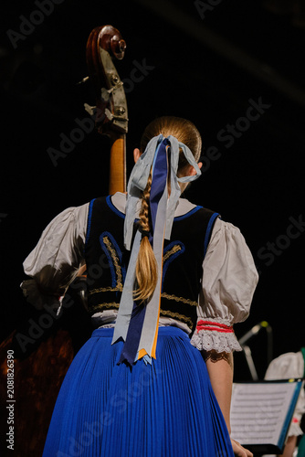 Beautiful girl playing the double bass, contrabass, folklore clef