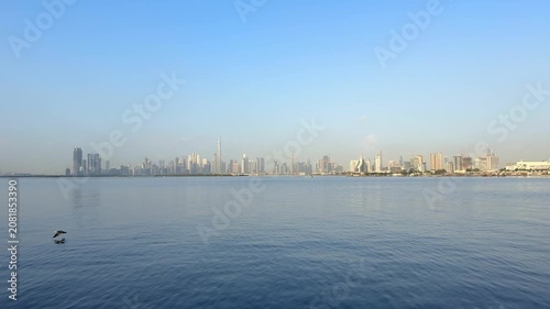 Wide panoramic view of Downtown Dubai and Burj Khalifa across Dubai Creek. Iconic waterfront skyline remains one of most recognized travel destinations in United Arab Emira