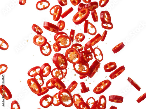 Fresh red chili pepper slices falling in the air