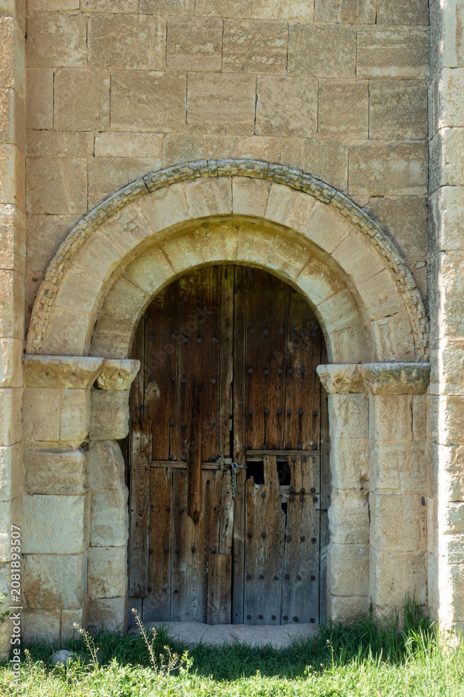 Fototapeta premium Southern Romanesque Carved Portal with Wooden Door from the 13th Century Hermitage of San Pedro in La Losa, Segovia, Castile and Leon, Spain
