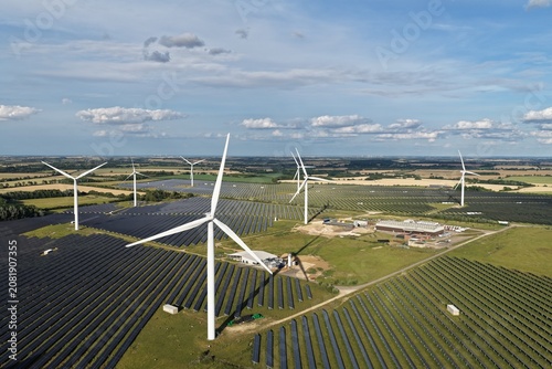Wind Turbines and Solar Farm Producing Clean Energy in a Rural Field