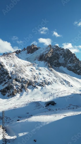 Vertical Aerial View of Snow Covered Glaciated Peaks and Alpine Valley in the Tien Shan Mountains at Shymbulak, Kazakhstan