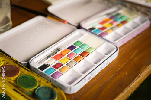 Fotografie Colorful poster colors on the wooden table. Creative workshop.