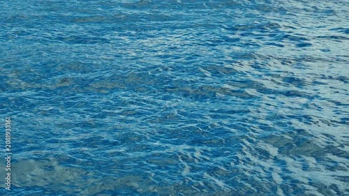 A serene sea surface in motion under natural lighting.