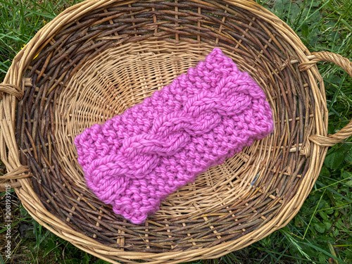a basket of knitting, hand knit headbands with cable stitch pattern 