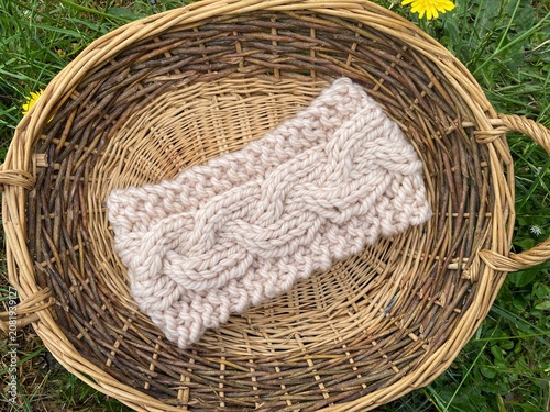 a basket of knitting, hand knit headbands with cable stitch pattern 