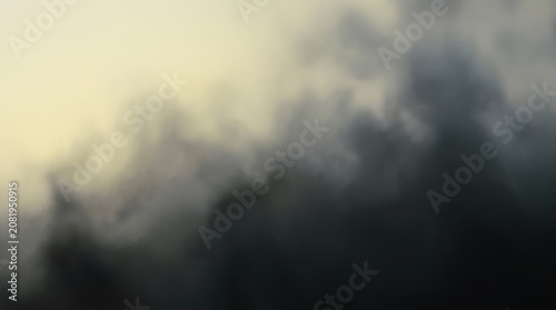 Moody clouds and fog over a dark horizon