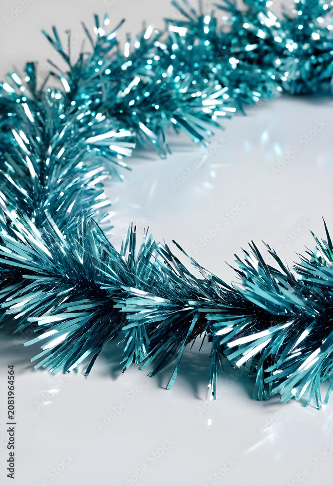 Fototapeta premium Blue metallic tinsel garland on white background