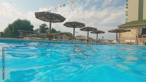 Happy family swim and play in blue pool. Father fun throw little child into water. Summer vacation holiday travel