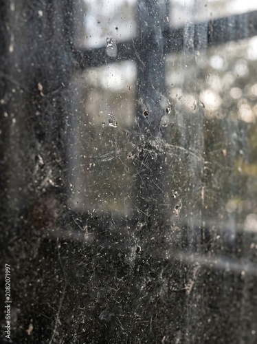 Dirty window glass texture with streaks and water spots.