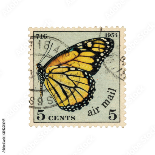 Vintage postage stamp with yellow and blue monarch butterfly wing illustration, aged paper texture, black ink postmarks, olive-green background, nostalgia vibe