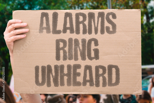 Slika na platnu "Alarms ring unheard" Warnings sound but nobody acts