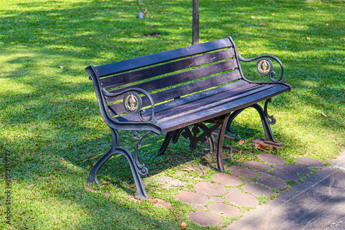 Classic iron bench in green public park