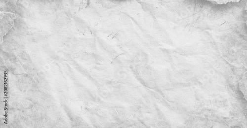 Fotografie A high-resolution close-up of a white crumpled paper texture with soft shadows,