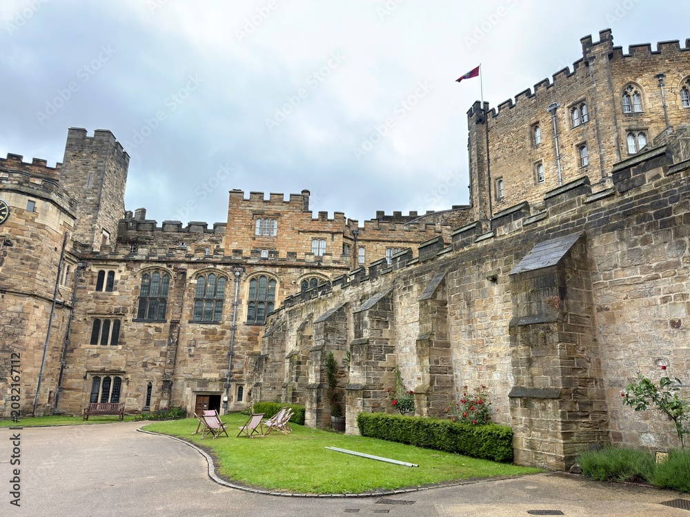 Fototapeta premium Enduring Medieval Palace Complex: A breathtaking distant perspective showcasing the magnificent terraced stone walls, complex architectural layers, and historic multi-level design of an ancient royal 